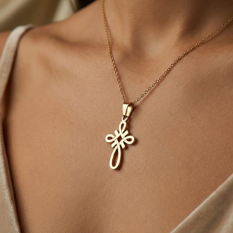 A small gold-tone cross pendant (chain not included), crafted from rust-resistant stainless steel, featuring a sleek, openwork knot design. A distinctive, modern, and spiritual piece. - Image 4
